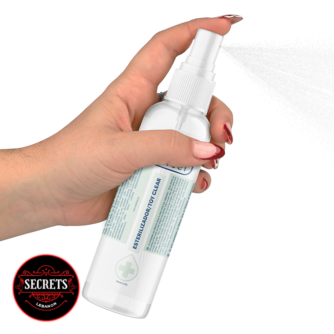 Antibacterial Toy Cleaner Spray clear bottle with white pump on green background
