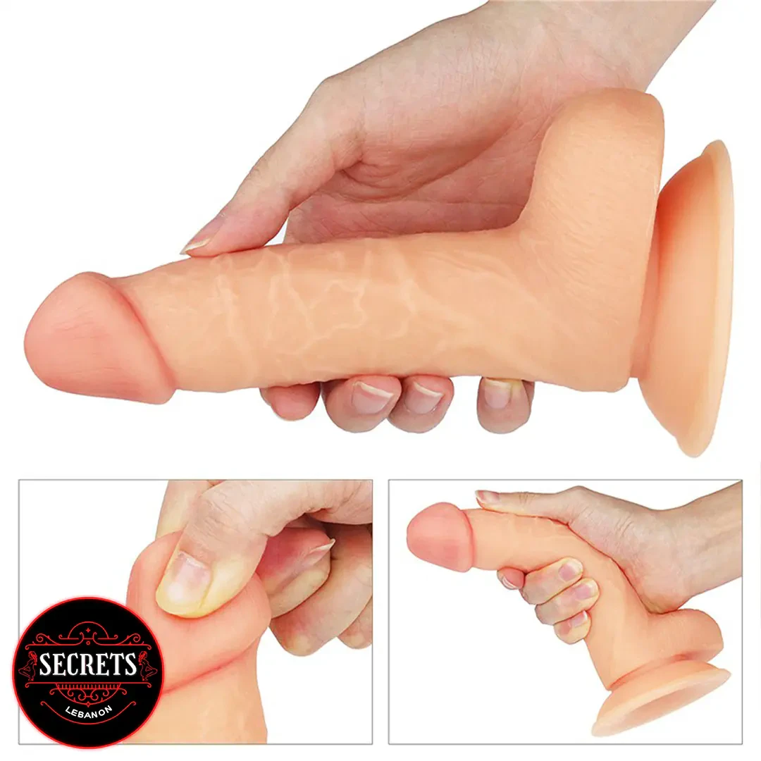 7 Inch Ultra Soft Realistic Dildo held in hand with suction cup base visible