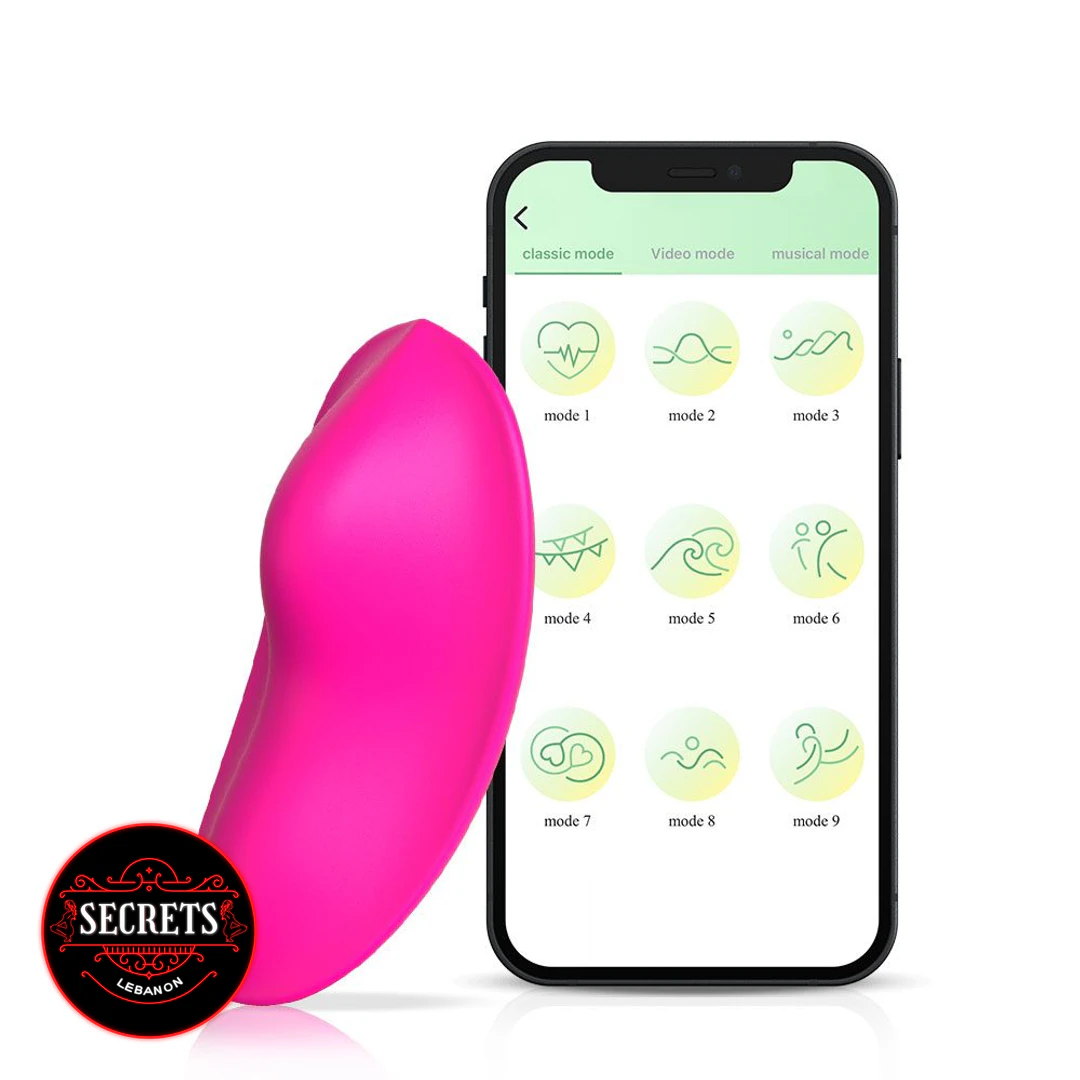 9 Mode App Controlled Wearable Vibrator in pink beside smartphone app