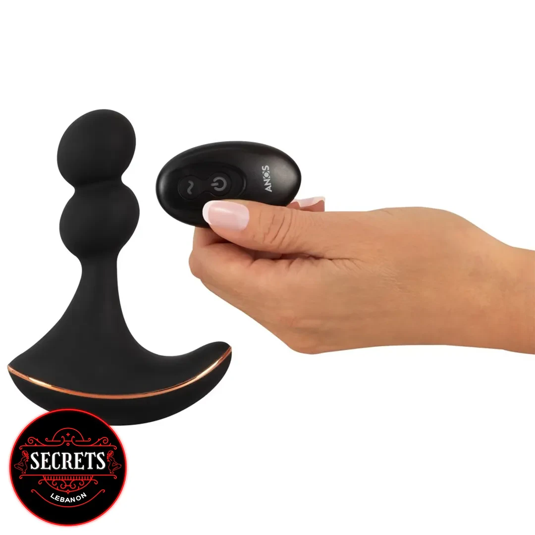 Anos Rotating Silicone Prostate Massager with wireless remote held by hand