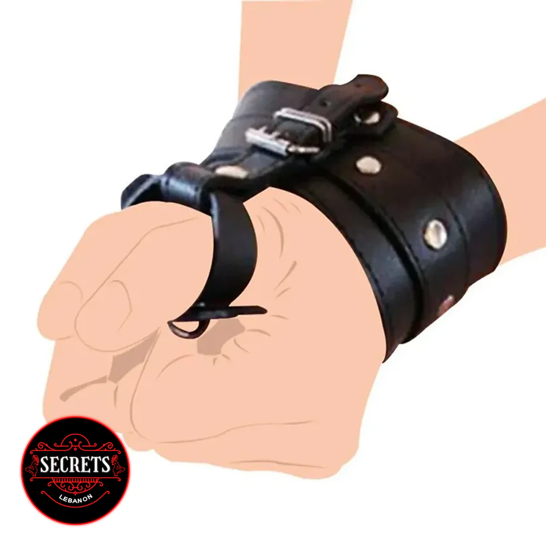Black Leather Buckle Bondage Cuff with metal hardware worn on clenched fist