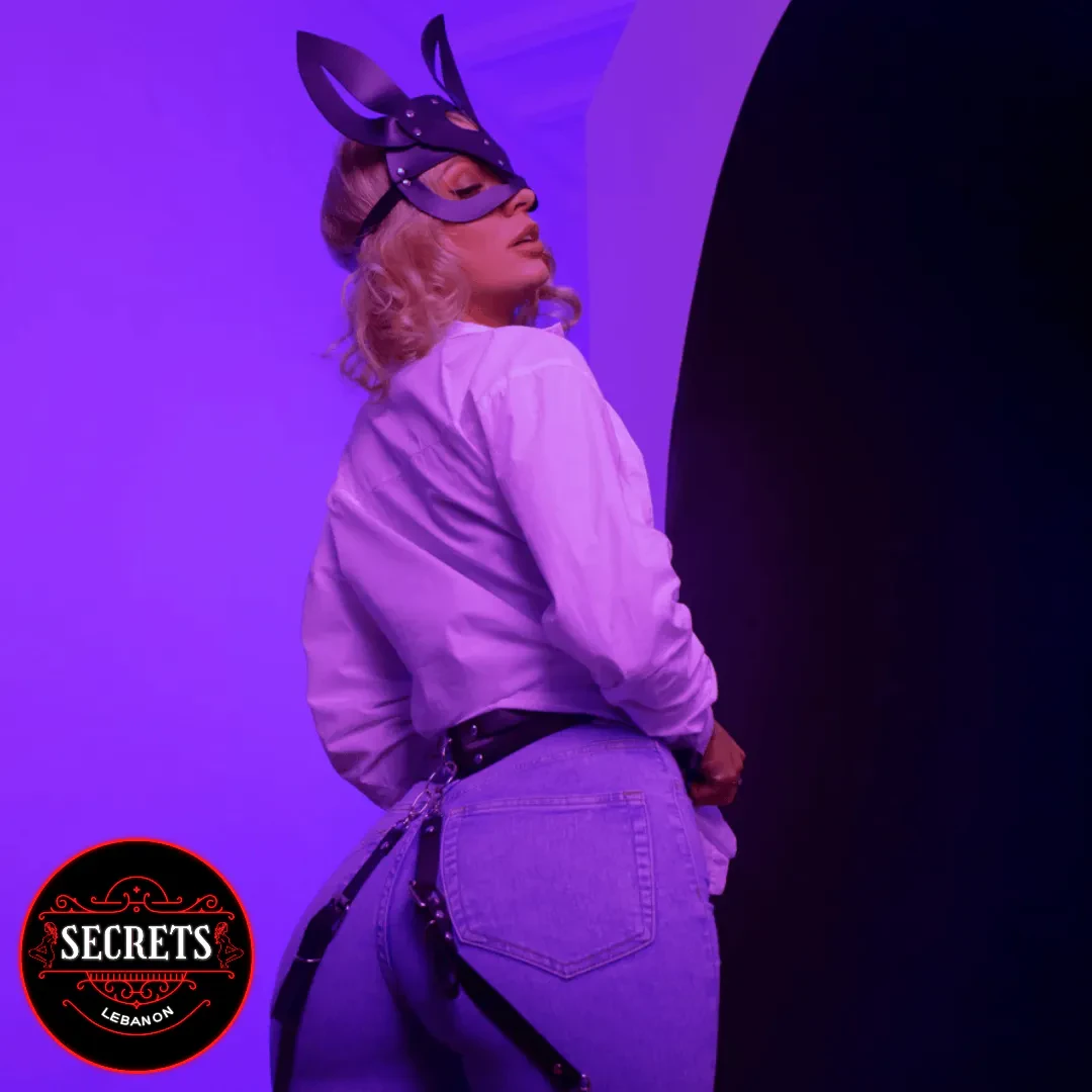Black Leather Bunny Fetish Mask worn with black harness under purple light