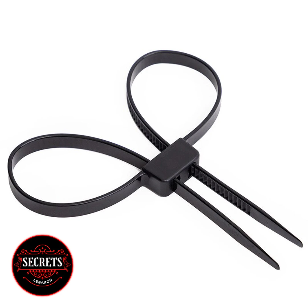 Black Zip Tie Bondage Cuffs forming two loops on white background