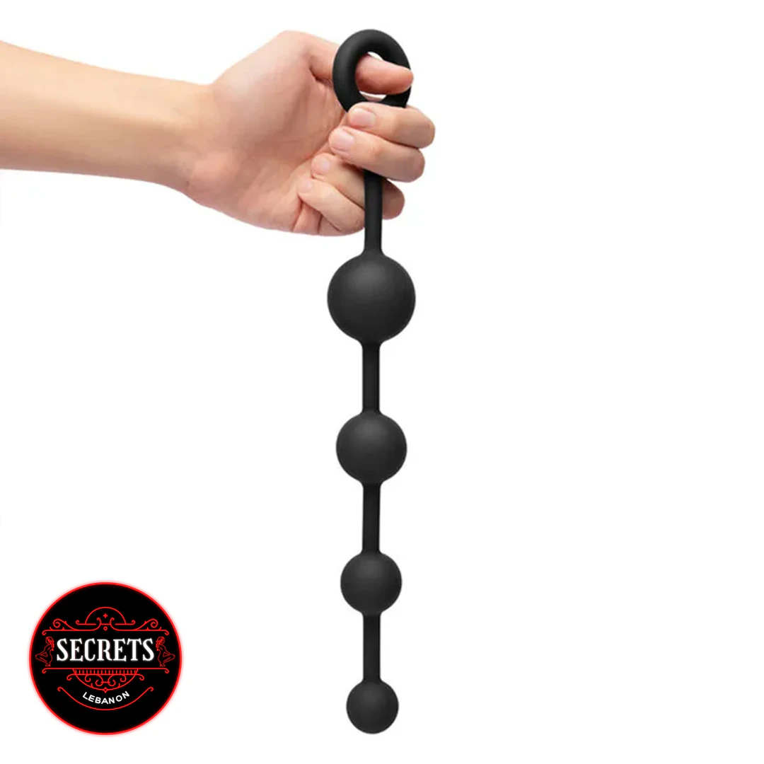 BlackOut Flexible Silicone Anal Beads with ring handle held by hand