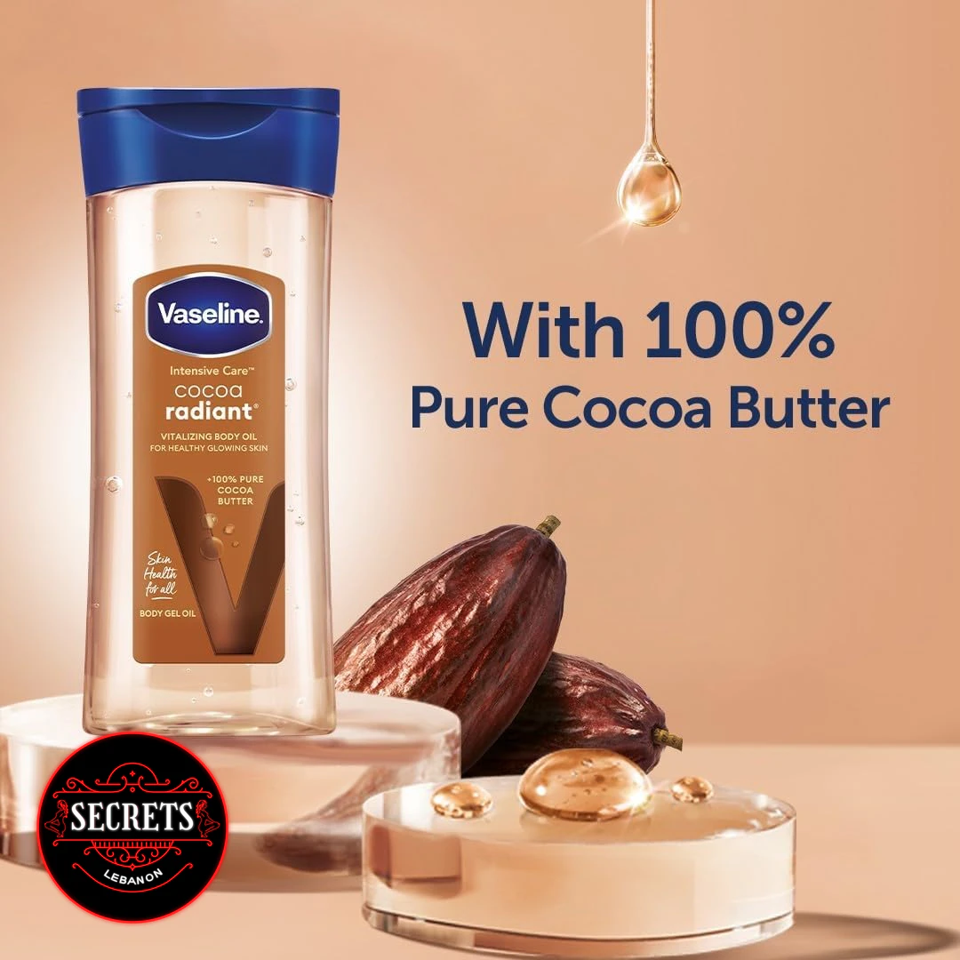 Cocoa Butter Vitalizing Body Oil bottle beside dark cocoa pods on warm background
