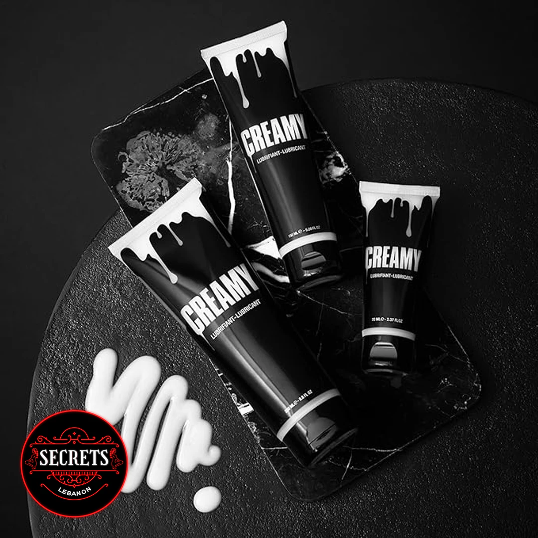 Creamy Cum Lubricant 150ml black tubes displayed on dark stone surface