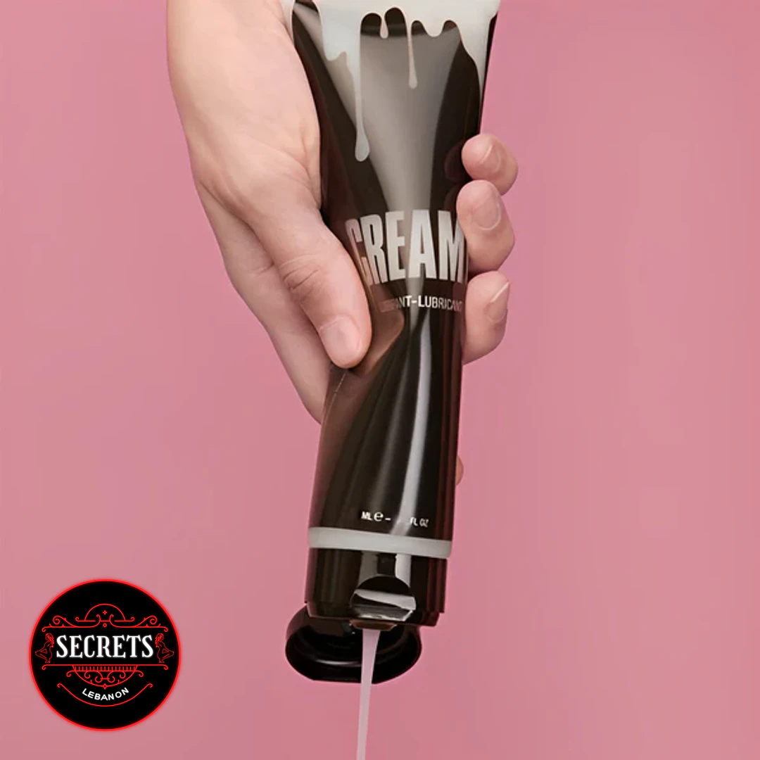 Creamy Cum Lubricant 150ml dark tube held upside down dispensing white fluid