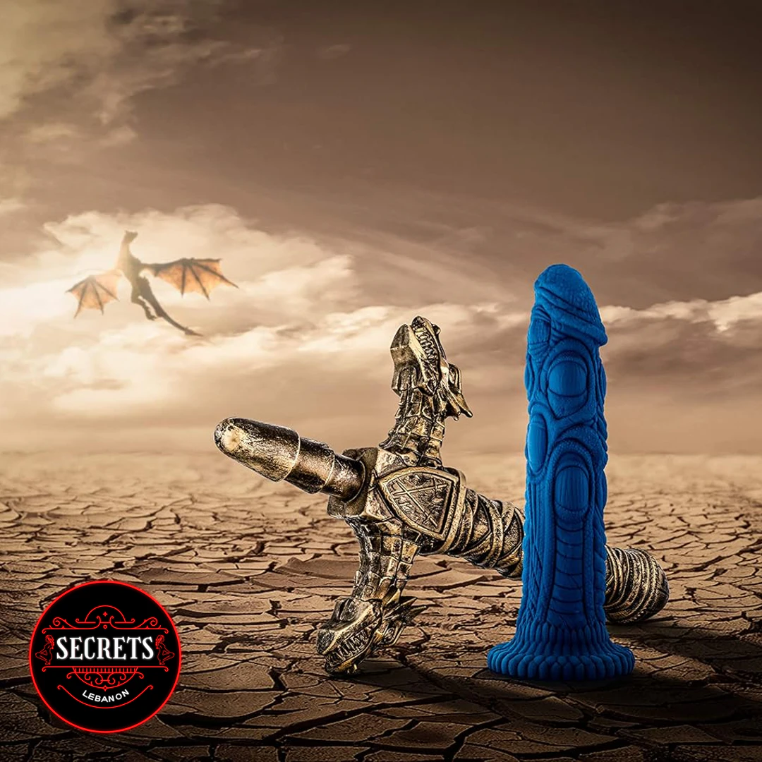 Draken Fantasy Silicone Dildo in blue with dragon figurine on cracked earth