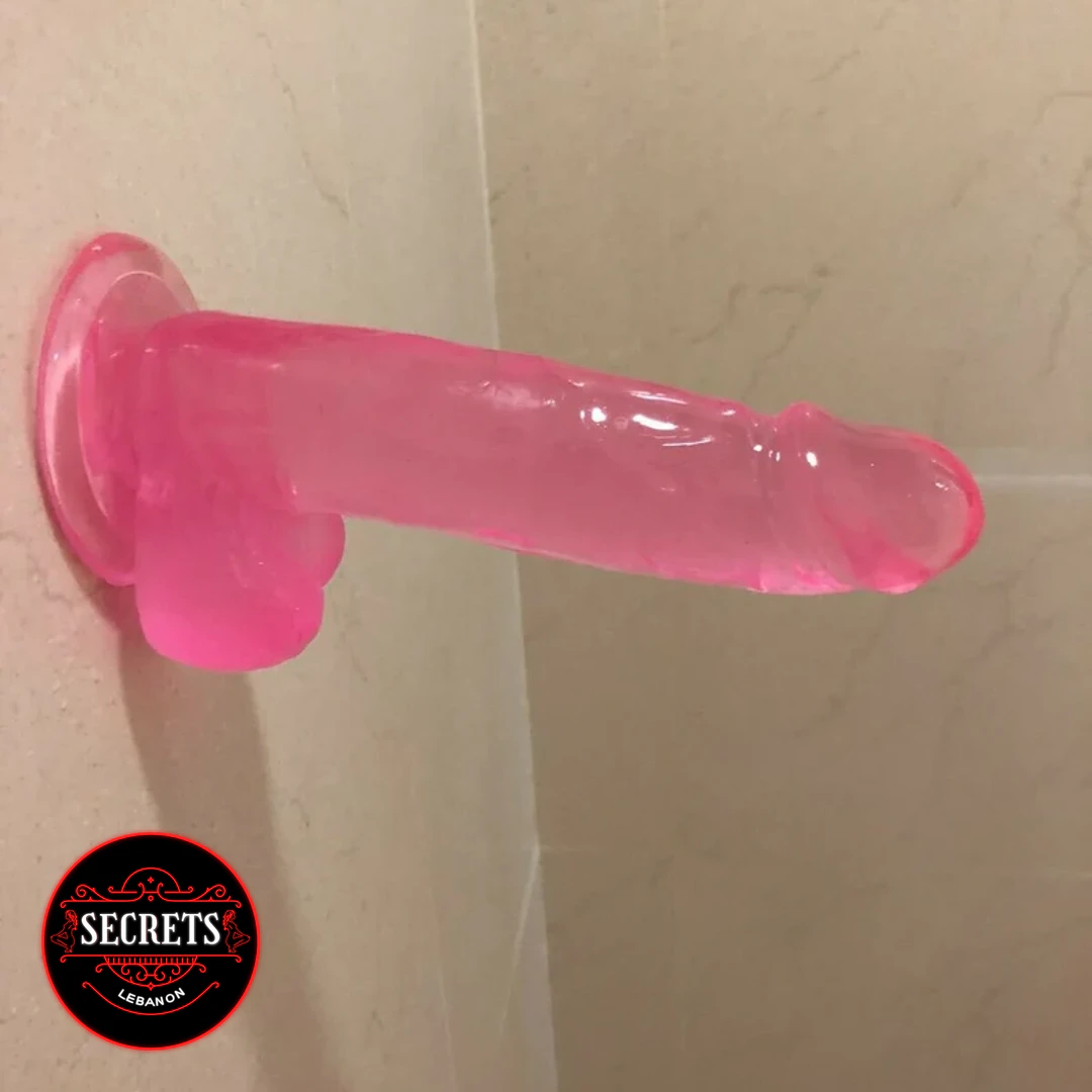 FlexCore Suction Base Dildo mounted on tile wall pink translucent jelly