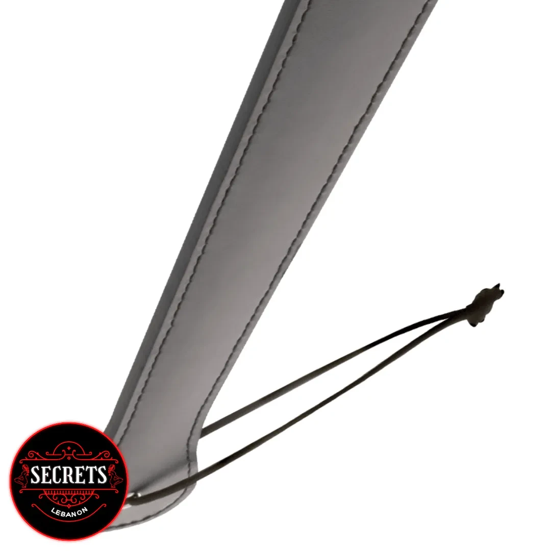 Long Faux Leather Spanking Paddle close-up with grey stitching and wrist loop