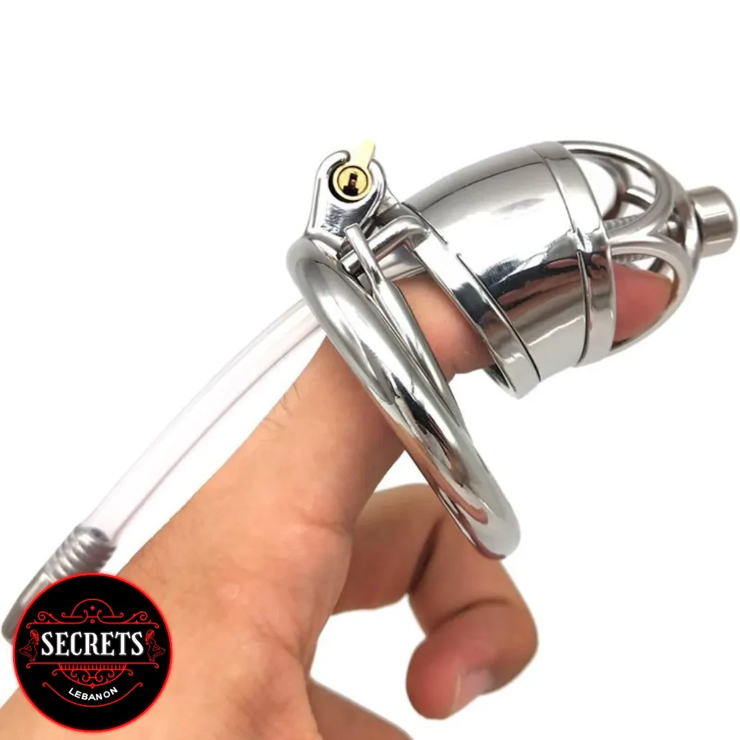 Metal Chastity With Catheter held in hand showing polished silver cage and lock