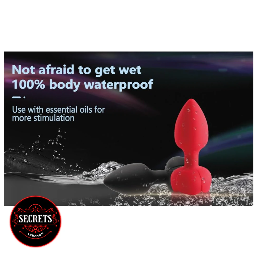 RedBloom Remote Anal Vibrator in red and black submerged in water splashes