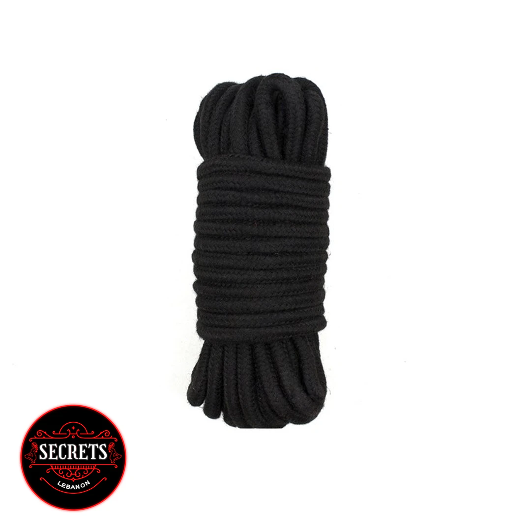 7 Piece Beginners BDSM Kit black cotton rope coiled on white background