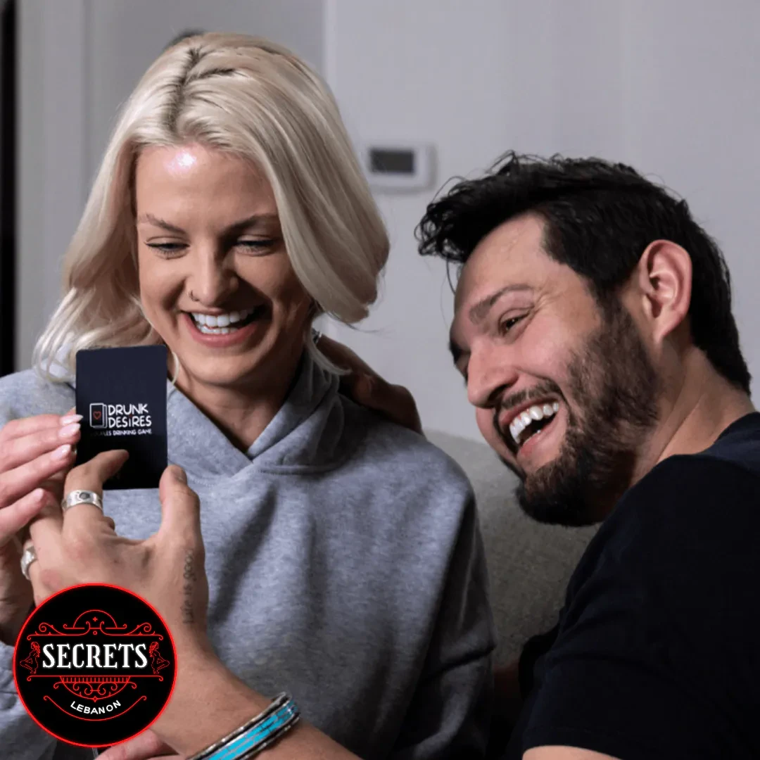 After Dark Couples Drinking Game card held by laughing couple together