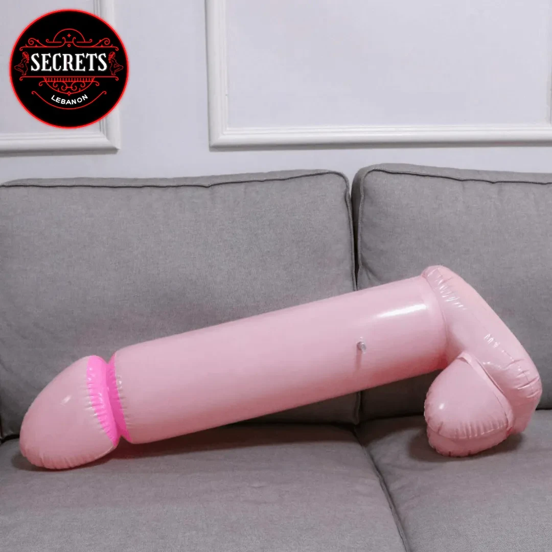 Bachelorette Party Penis Balloon large pink inflatable lying on grey sofa