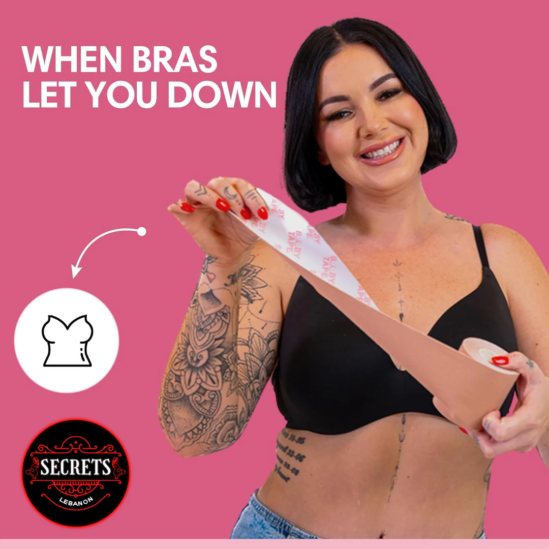 Booby Tape Original Breast Lift Roll peeled by tattooed model in black bra