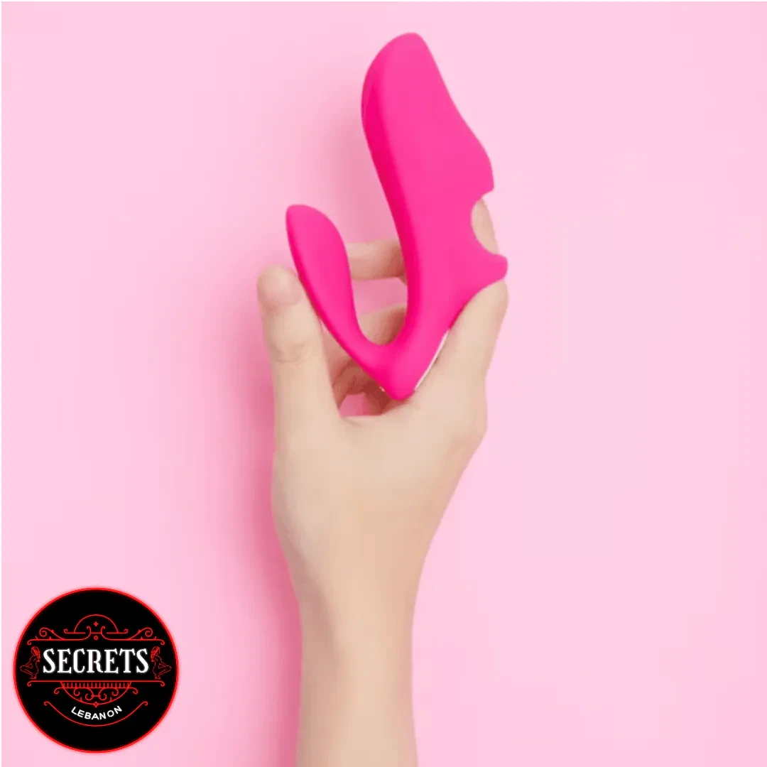 FlexWing Silicone Finger Vibrator held in hand against pink background