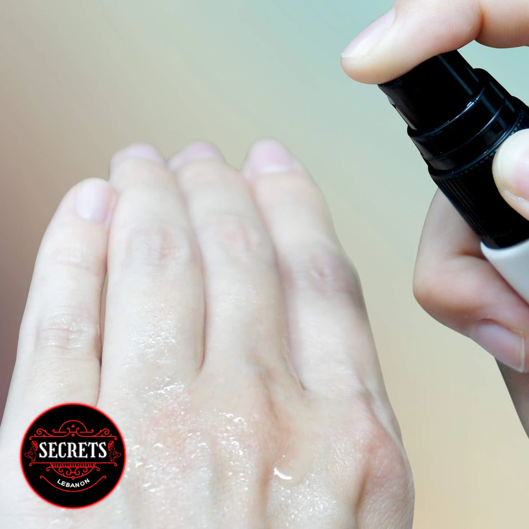 Pjur Back Door Anal Comfort Spray being spritzed onto wet hands close-up