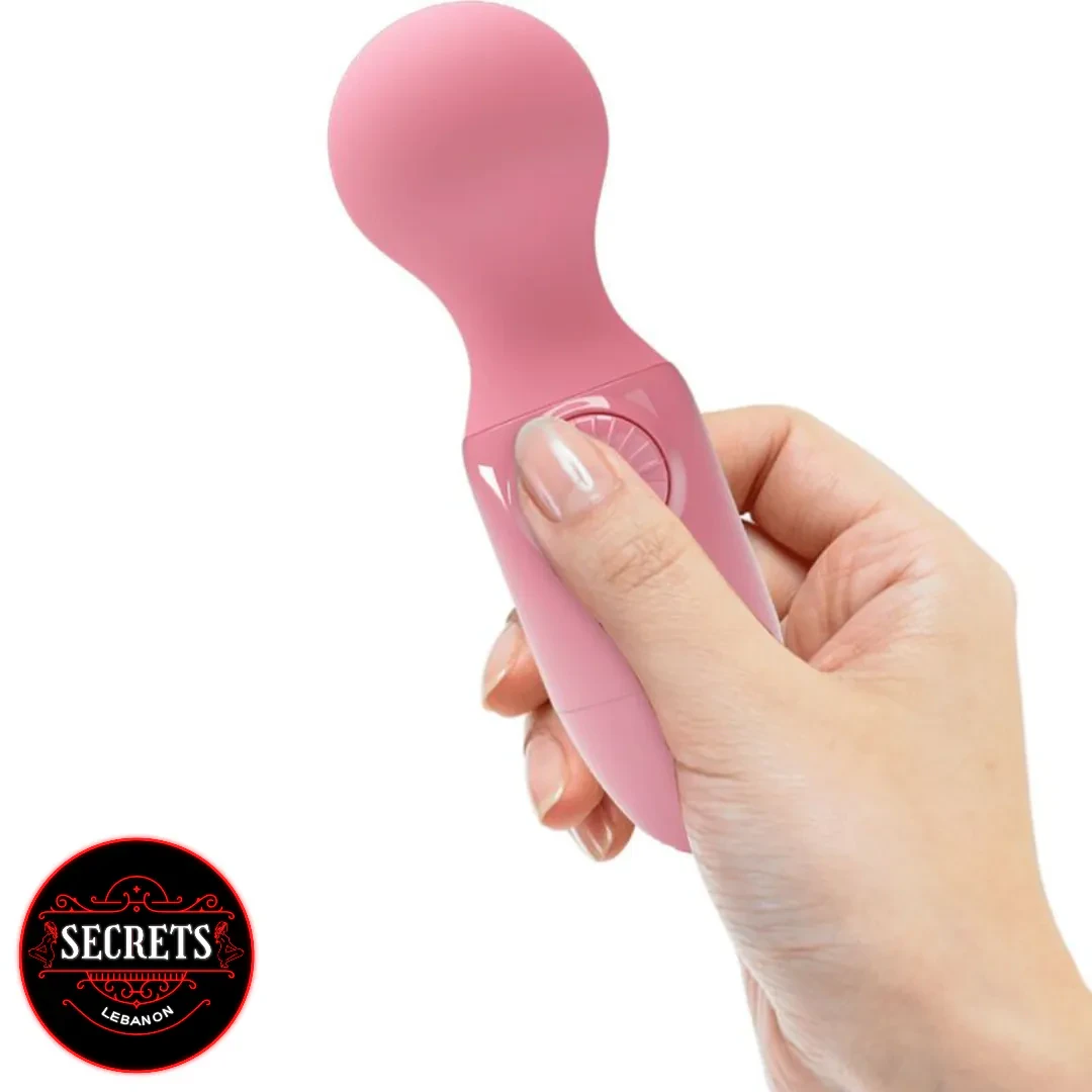 Wonder Mini Stick Vibrator held in hand showing pink silicone wand design